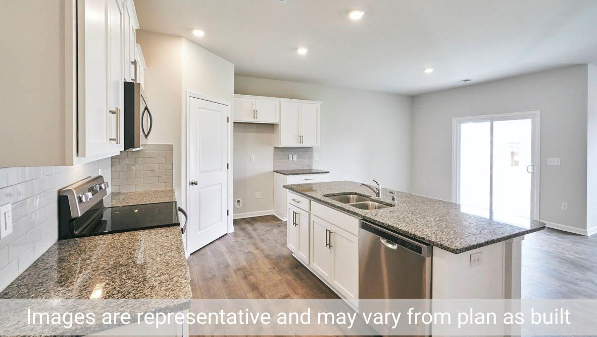7663 Sand Pit Road Stantonsburg, NC 27883 - Photo 10 of 22 a kitchen with stainless steel appliances granite countertop a stove and a sink
