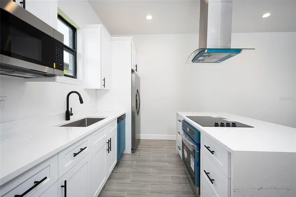 a kitchen with a stove and a refrigerator