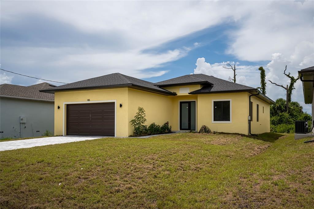 185 Sesame Road East Rotonda West, FL 33947 - Photo 3 of 60 a view of a house with a yard