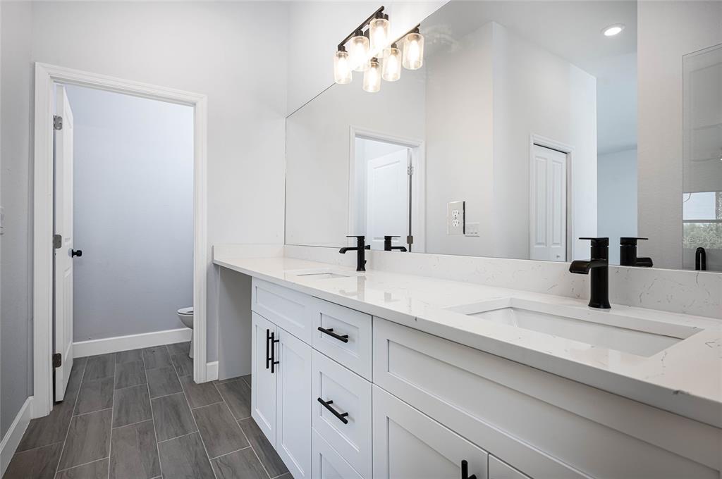 185 Sesame Road East Rotonda West, FL 33947 - Photo 31 of 60 a bathroom with a sink vanity granite and a mirror