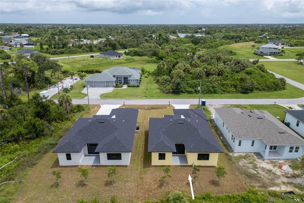 185 Sesame Road East Rotonda West, FL 33947 - Photo 41 of 60 an aerial view of multiple houses with a yard