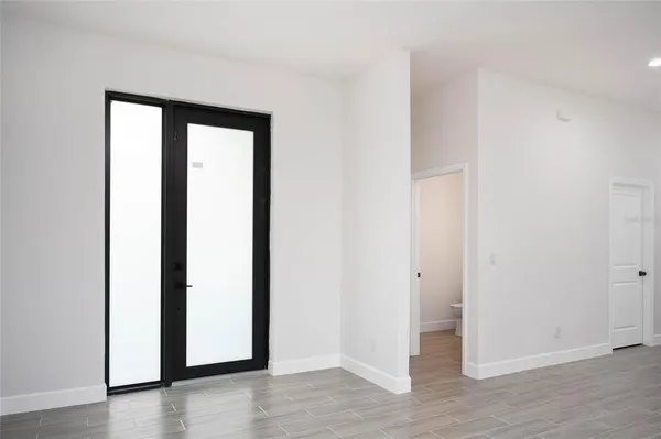 an empty room with wooden floor and closet