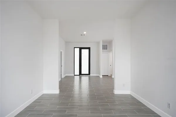 a view of an empty room with glass door