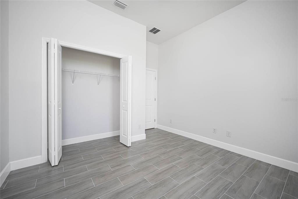 185 Sesame Road East Rotonda West, FL 33947 - Photo 10 of 60 a view of an empty room with wooden floor