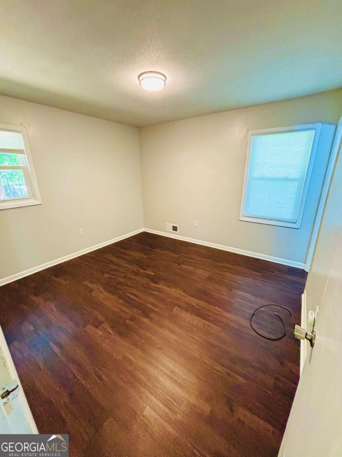 445 Vincent Drive Athens, GA 30607 - Photo 13 of 21 an empty room with wooden floor and windows