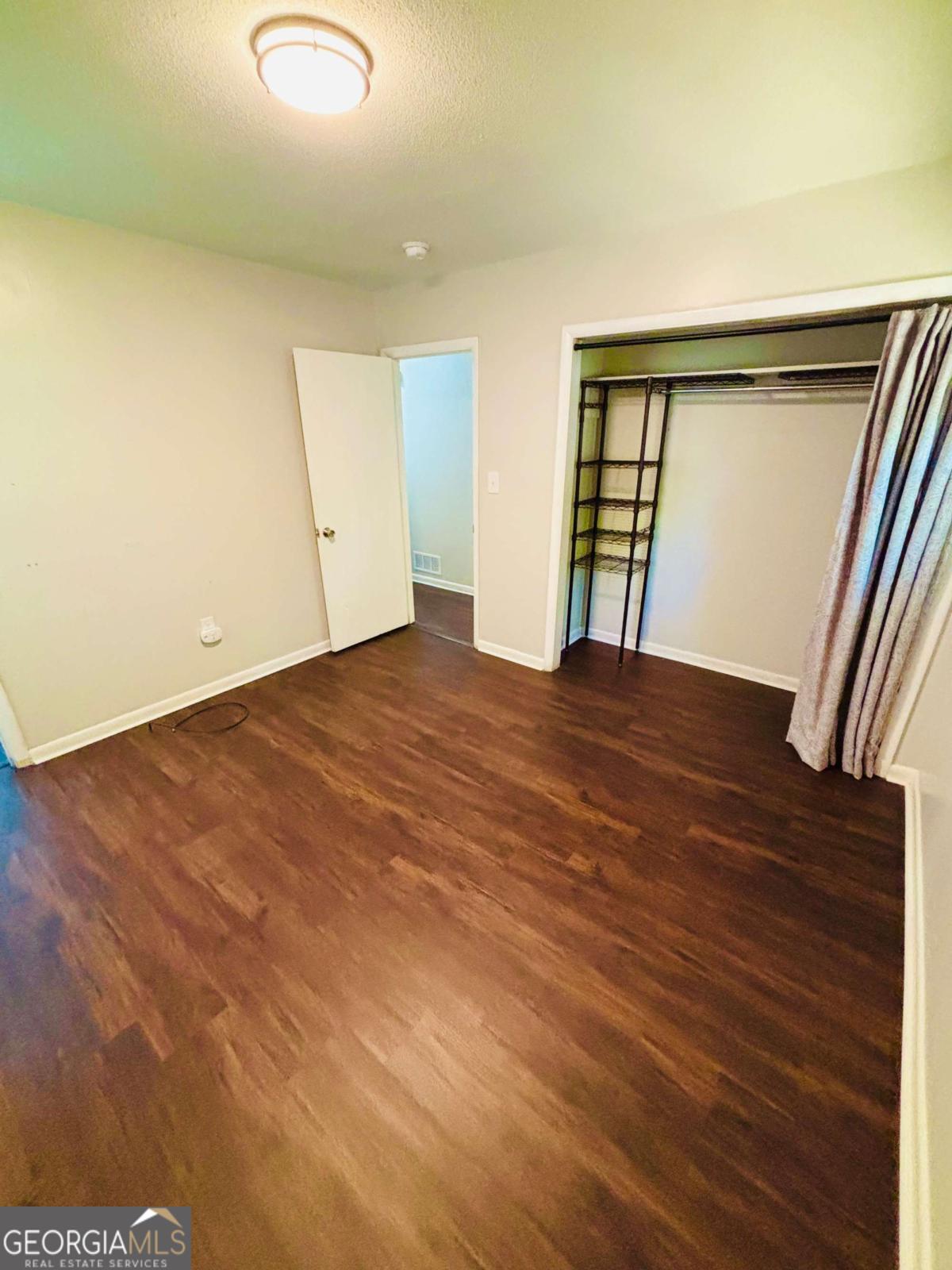 445 Vincent Drive Athens, GA 30607 - Photo 16 of 21 an empty room with wooden floor and windows