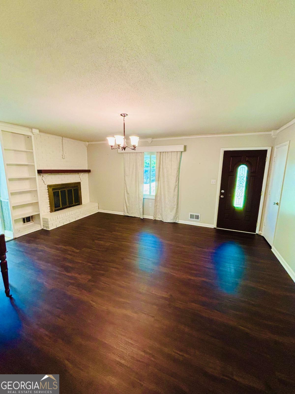 445 Vincent Drive Athens, GA 30607 - Photo 3 of 21 an empty room with wooden floor fireplace and windows