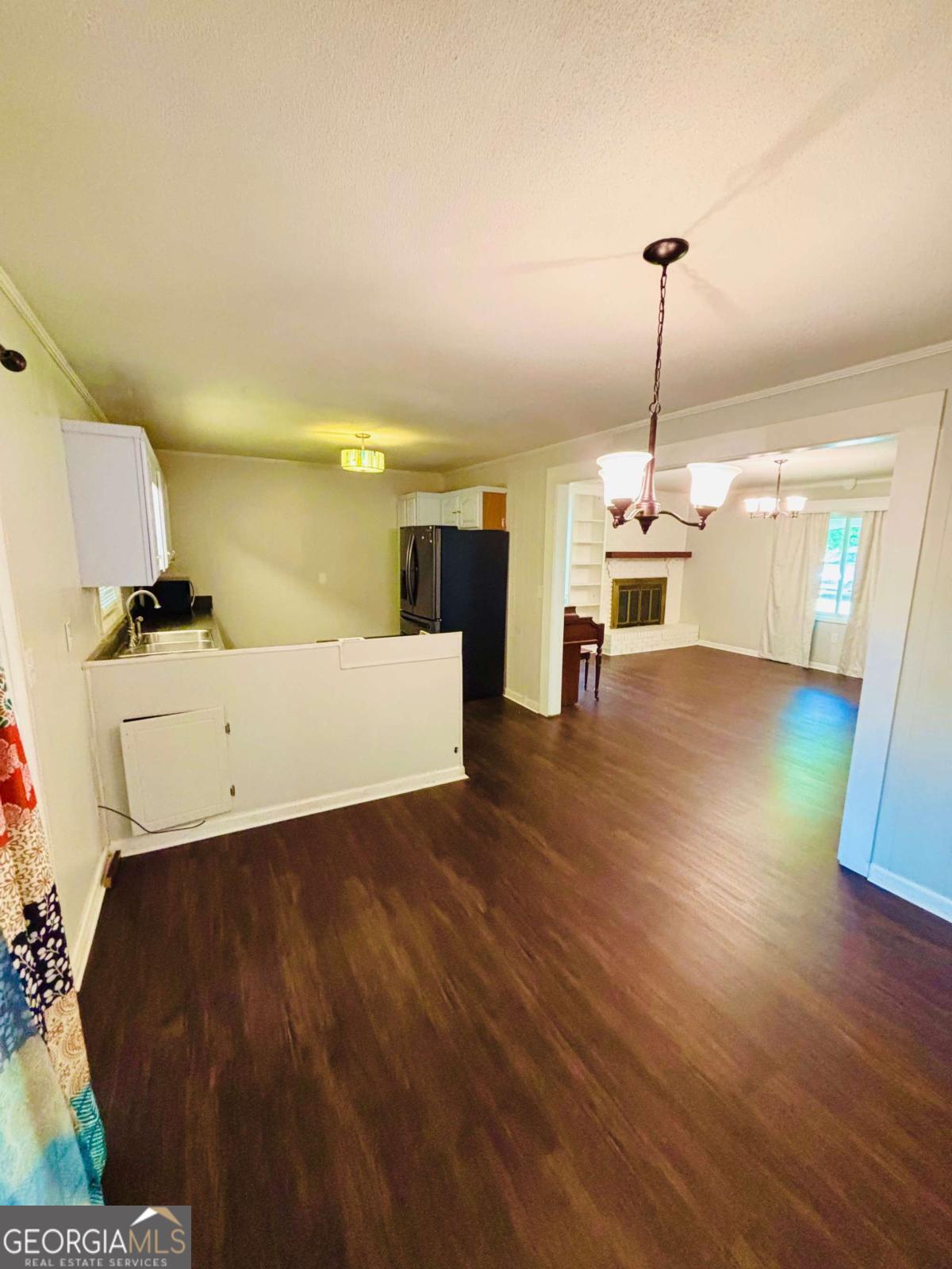 445 Vincent Drive Athens, GA 30607 - Photo 7 of 21 a view of a livingroom and a kitchen with furniture wooden floor