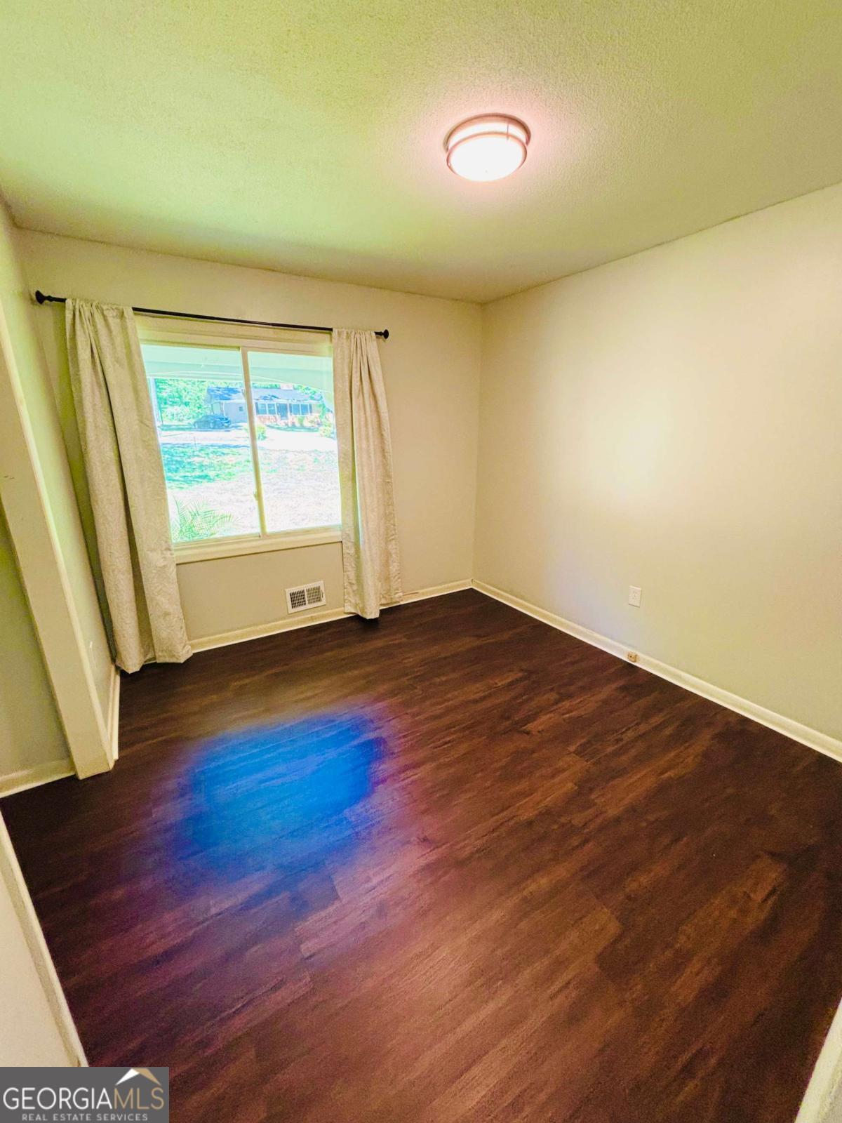 445 Vincent Drive Athens, GA 30607 - Photo 9 of 21 an empty room with wooden floor and windows