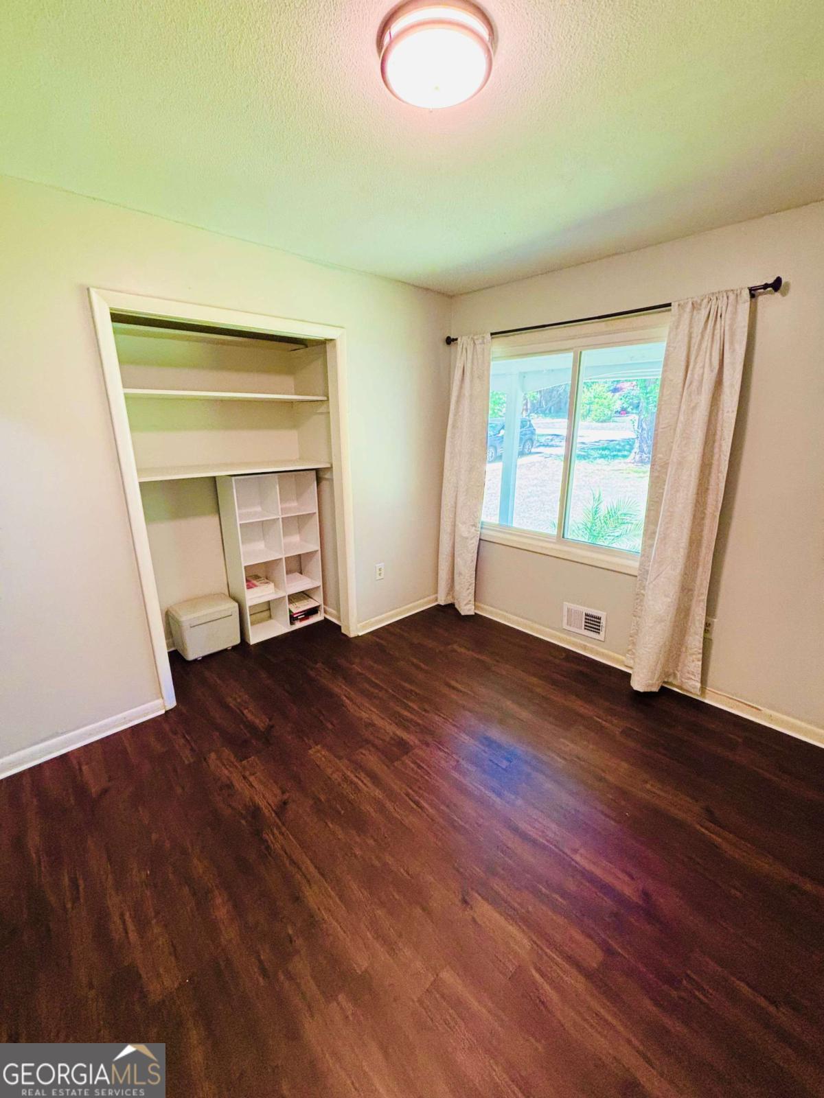 445 Vincent Drive Athens, GA 30607 - Photo 10 of 21 an empty room with wooden floor and windows