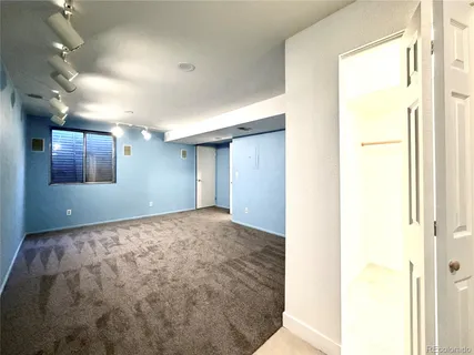 a view of an empty room and a window