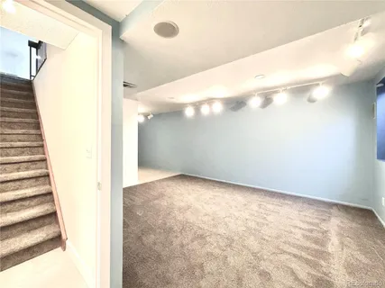 a view of a big room with entryway and stairs