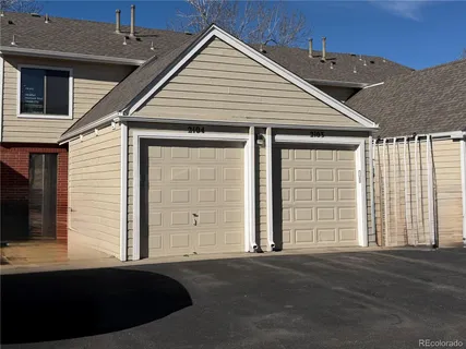 a front view of a house with a parking space