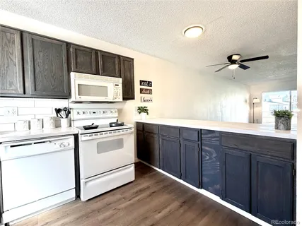 a kitchen with a stove cabinets and a sink