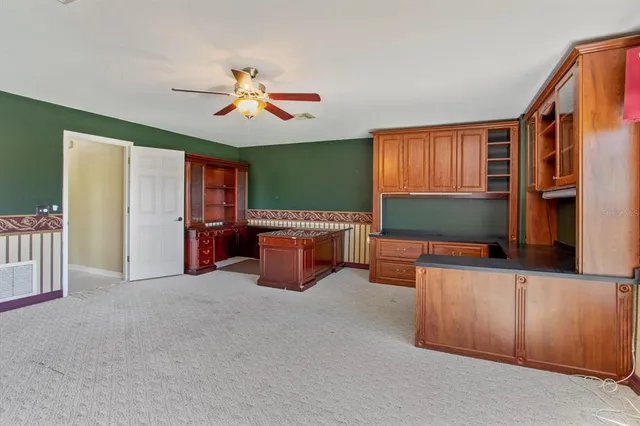 a view of an empty room with a kitchen