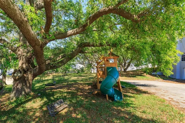 a house that has a tree in front of it