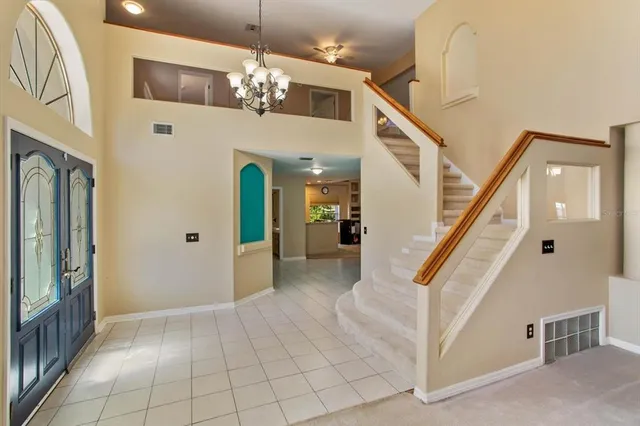a view of a livingroom with furniture and stairs