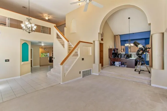 a view of a livingroom with furniture and stairs