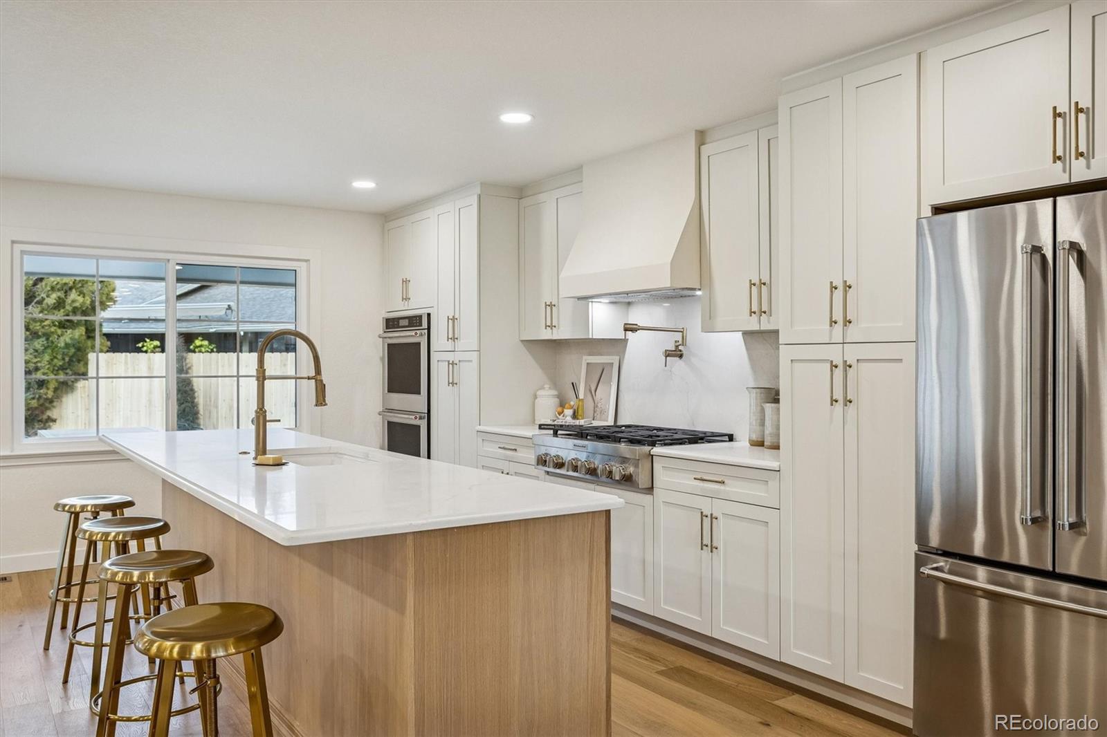 4872 Country Club Way Boulder, CO 80301 - Photo 13 of 48 a kitchen with stainless steel appliances granite countertop a refrigerator a stove a sink and white cabinets with wooden floor