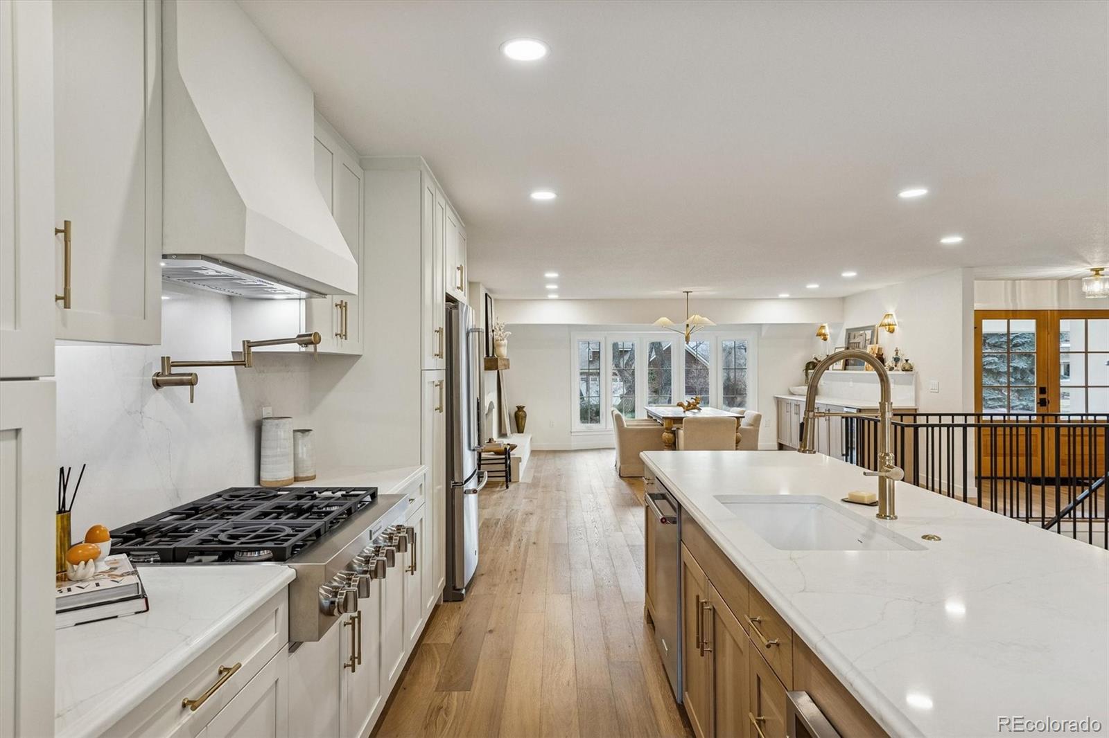 4872 Country Club Way Boulder, CO 80301 - Photo 14 of 48 a kitchen with stainless steel appliances a stove a sink dishwasher and a refrigerator with wooden floor