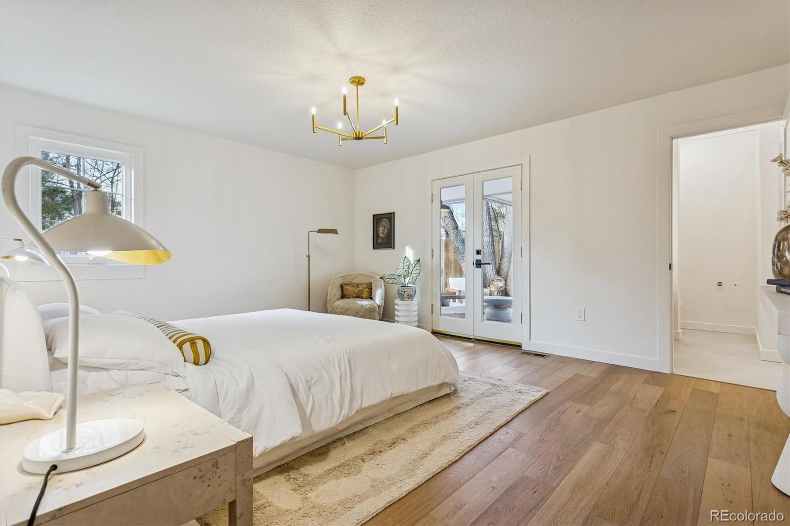 4872 Country Club Way Boulder, CO 80301 - Photo 19 of 48 a bedroom with a bed and a chandelier