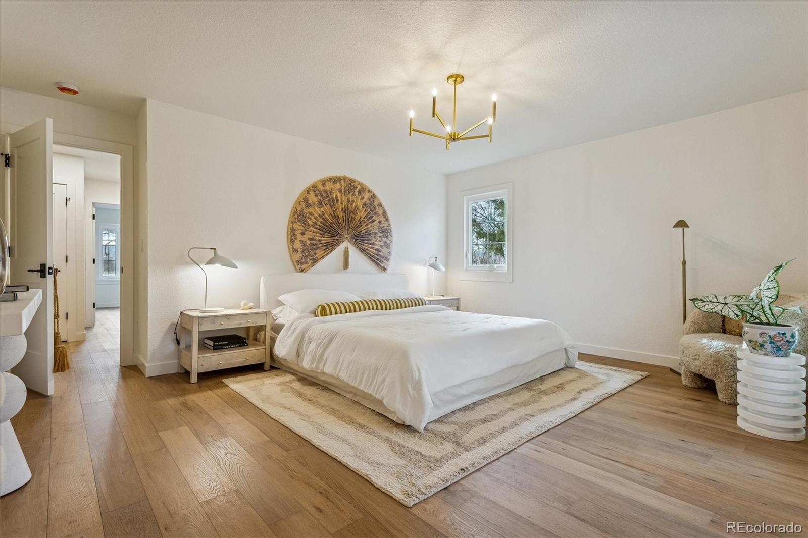 4872 Country Club Way Boulder, CO 80301 - Photo 22 of 48 a bedroom with a bed and a chandelier