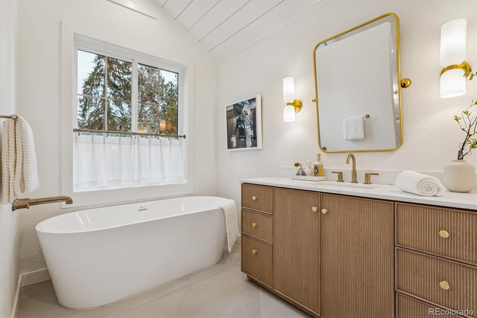 4872 Country Club Way Boulder, CO 80301 - Photo 25 of 48 a bathroom with a bathtub a sink and a window