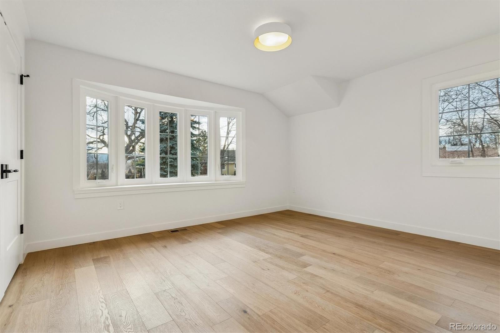 4872 Country Club Way Boulder, CO 80301 - Photo 28 of 48 an empty room with wooden floor and windows