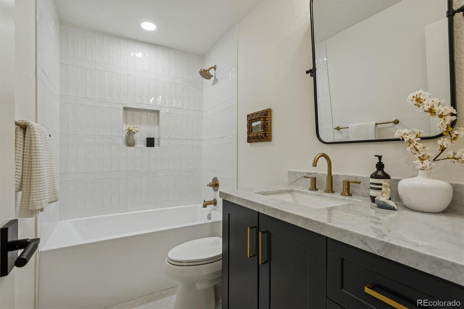 4872 Country Club Way Boulder, CO 80301 - Photo 29 of 48 a bathroom with a granite countertop sink toilet and shower