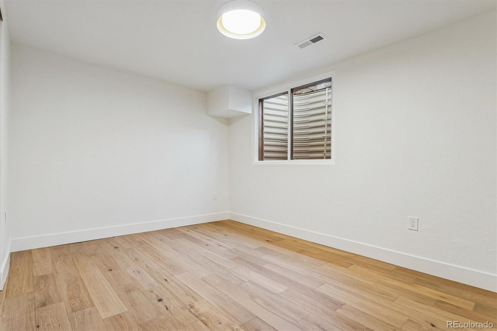 4872 Country Club Way Boulder, CO 80301 - Photo 34 of 48 an empty room with wooden floor and windows