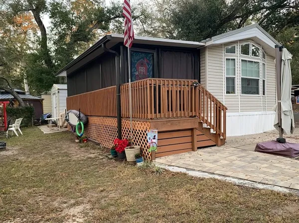 a view of backyard with deck and entertaining space
