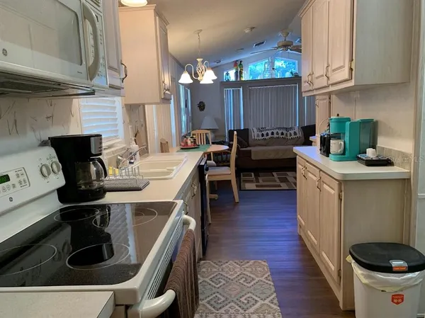 a kitchen with a sink appliances and cabinets