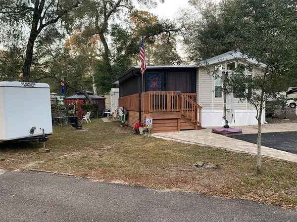 a view of a house with a yard and garage