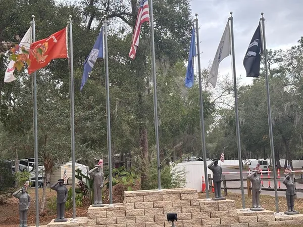 a row of lawn chairs under an umbrella
