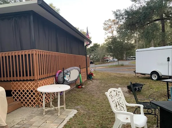 a view of a backyard with furniture
