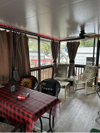 a dining room with furniture and a floor to ceiling window