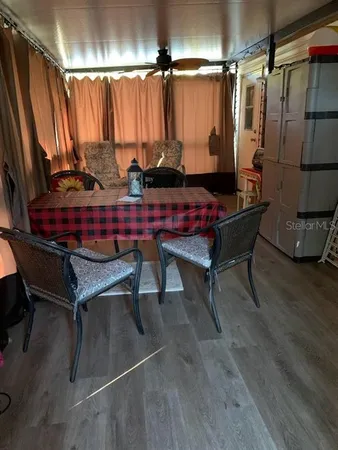 a dining room with furniture and a chandelier