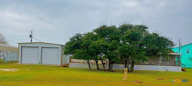 a open kitchen with stainless steel appliances granite countertop a refrigerator a stove a sink dishwasher and white cabinets with wooden floor