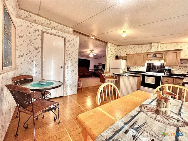 a living room with furniture a flat screen tv and a floor to ceiling window
