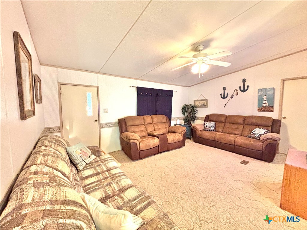 55 Scarlett Street Port O'Connor, TX 77982 - Photo 36 of 46 a large bedroom with a large bed and a couch