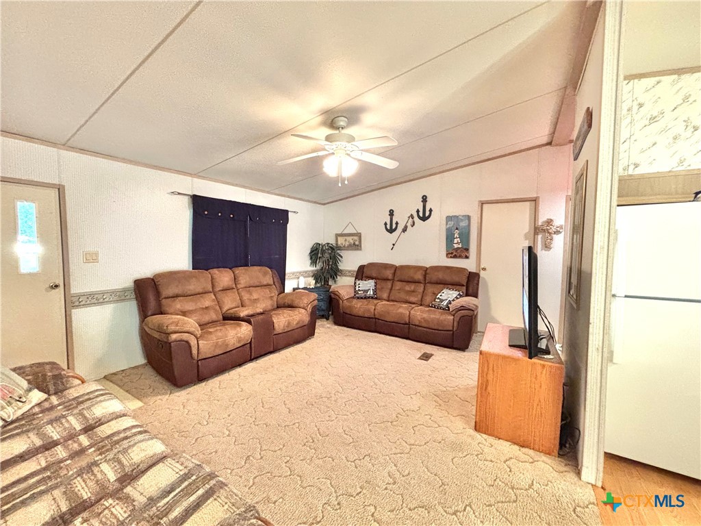 55 Scarlett Street Port O'Connor, TX 77982 - Photo 38 of 46 a living room with furniture and a chandelier