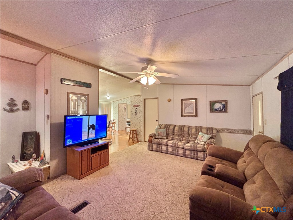 55 Scarlett Street Port O'Connor, TX 77982 - Photo 39 of 46 a living room with furniture a flat screen tv and gym equipment