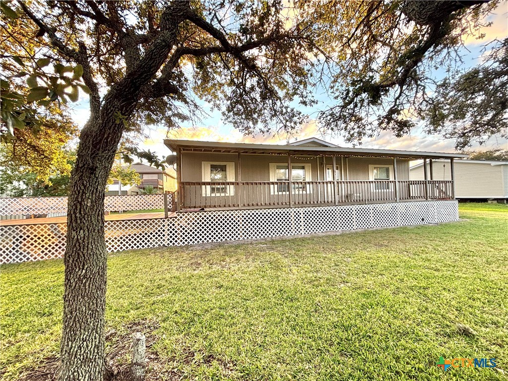 55 Scarlett Street Port O'Connor, TX 77982 - Photo 7 of 46 a front view of a house with a yard