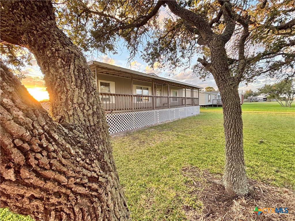 55 Scarlett Street Port O'Connor, TX 77982 - Photo 10 of 46 a backyard of a house with lots of green space