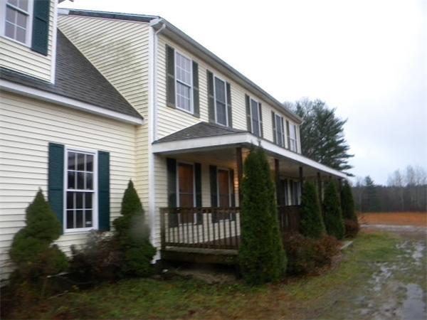 96 Sarah Sherman Road Rochester, MA 02770 - Photo 2 of 6 a view of a house with brick walls and a yard with plants