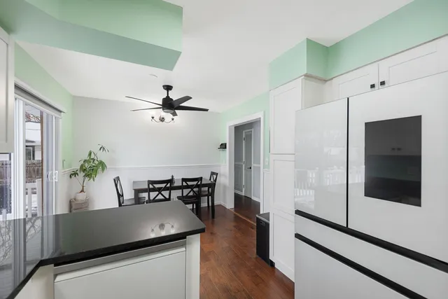 a dining room with furniture and wooden floor