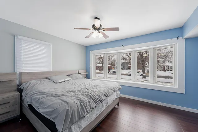 a bedroom with a large bed and a window