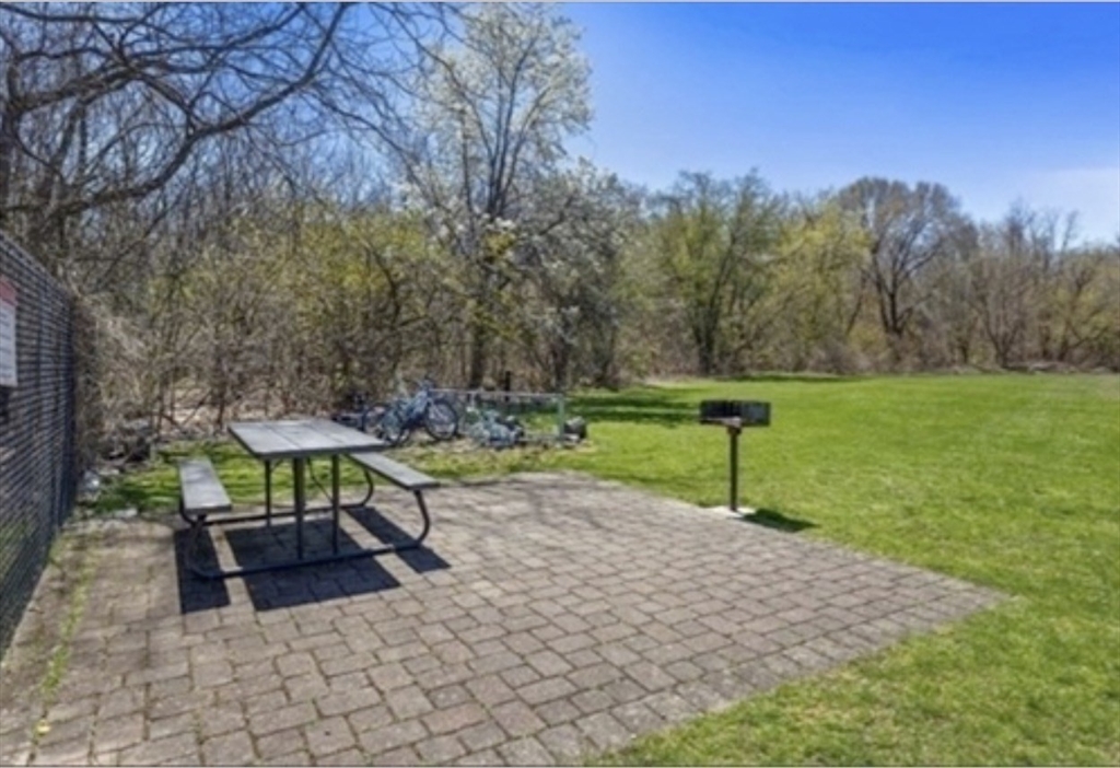 22 Westgate Road, Unit 3 Boston, MA 02467 - Photo 17 of 18 a view of a bench in a garden