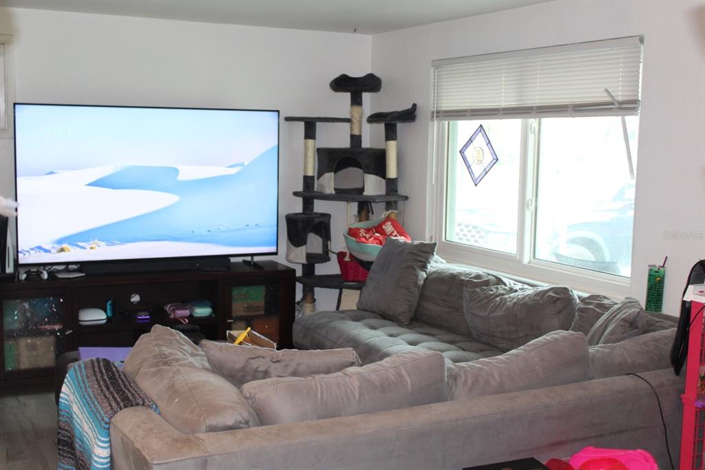 4928 Lake Ridge Lane Holiday, FL 34690 - Photo 3 of 7 a living room with furniture and a large window