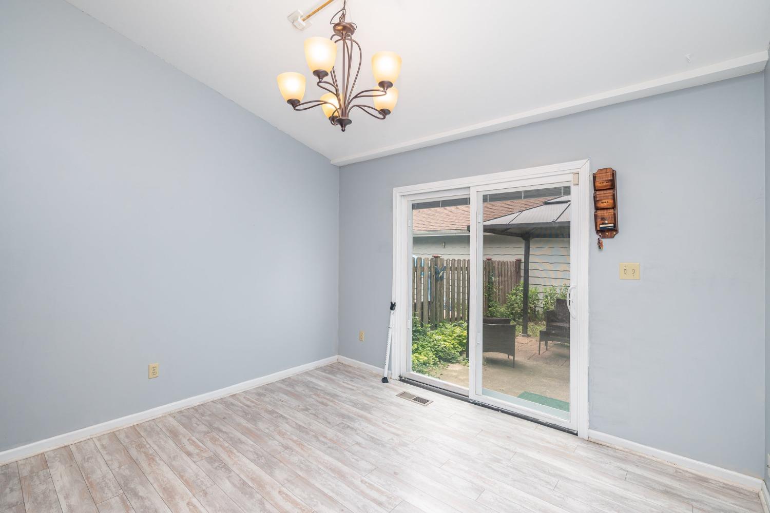225 Clinton Street Lowell, IN 46356 - Photo 11 of 27 a view of a livingroom with a chandelier fan and windows